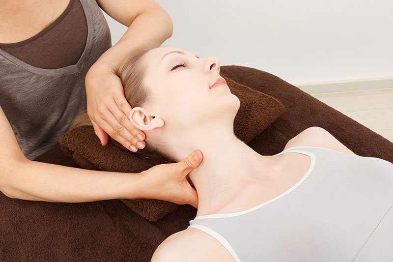 Dr. Atchison supporting a patient’s neck during a calm, gentle adjustment.
